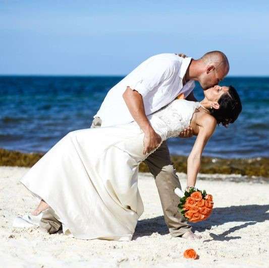 groom and bride on white sand beach