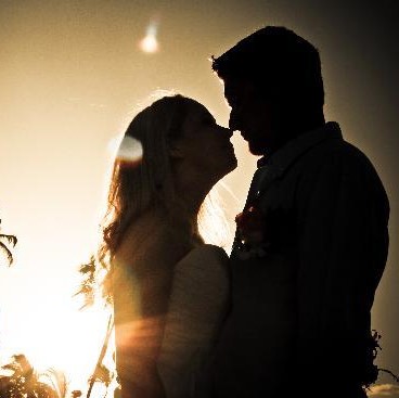 wedding couple silhouetted at sunset