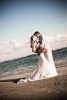 groom and bride kiss oceanside