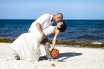 groom and bride on white sand beach